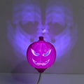 Plastic pumpkin-shaped decorative lamp with USB cable, showing yellow or purple LED light option.