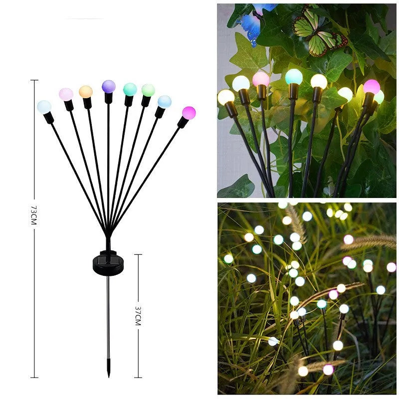 Solar-powered LED firefly garden spike light with multiple heads and a press-in ground plug on grass.