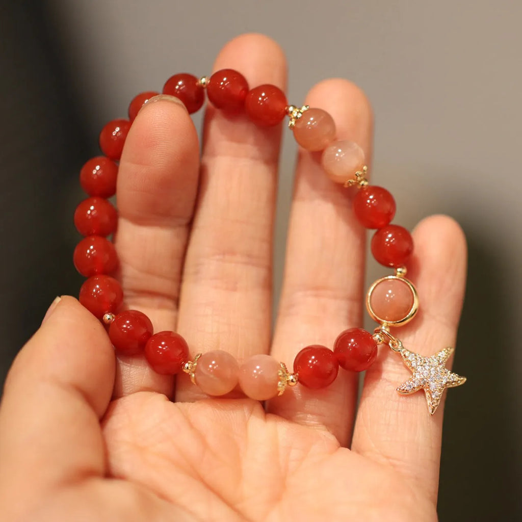 Handmade red agate and orange sunstone bracelet with star and cloud motifs