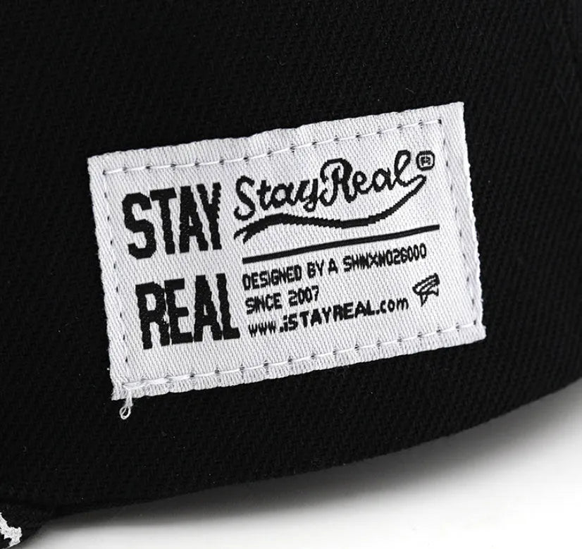 Adjustable black cotton baseball cap with white letter embroidery on the front, showing dome crown shape.