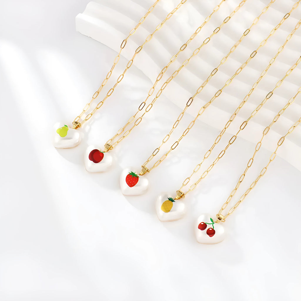 Heart-shaped necklace with fruit pendant on geometric chain showing strawberry pineapple apple pear cherry options