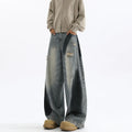 Men's blue ripped jeans with splash-ink design detail showing cotton fabric with micro elasticity