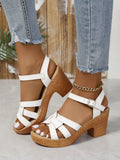 Plus size women's black peep toe sandals with chunky heel and ankle-strap buckle.