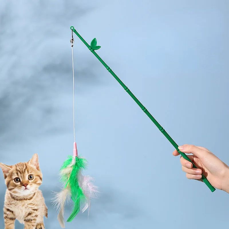 Green interactive cat feather wand toy with bell attachment on a durable stick
