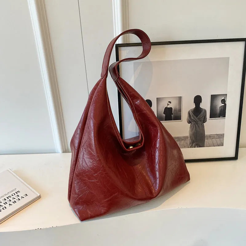 Soft PU leather large capacity shoulder bag in black with a sandwich pocket and contrasting stitching.