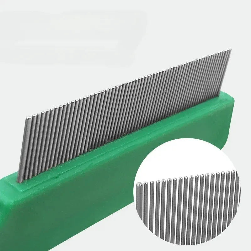 Green plastic handle stainless steel pin pet flea comb for dogs and cats on a white background.