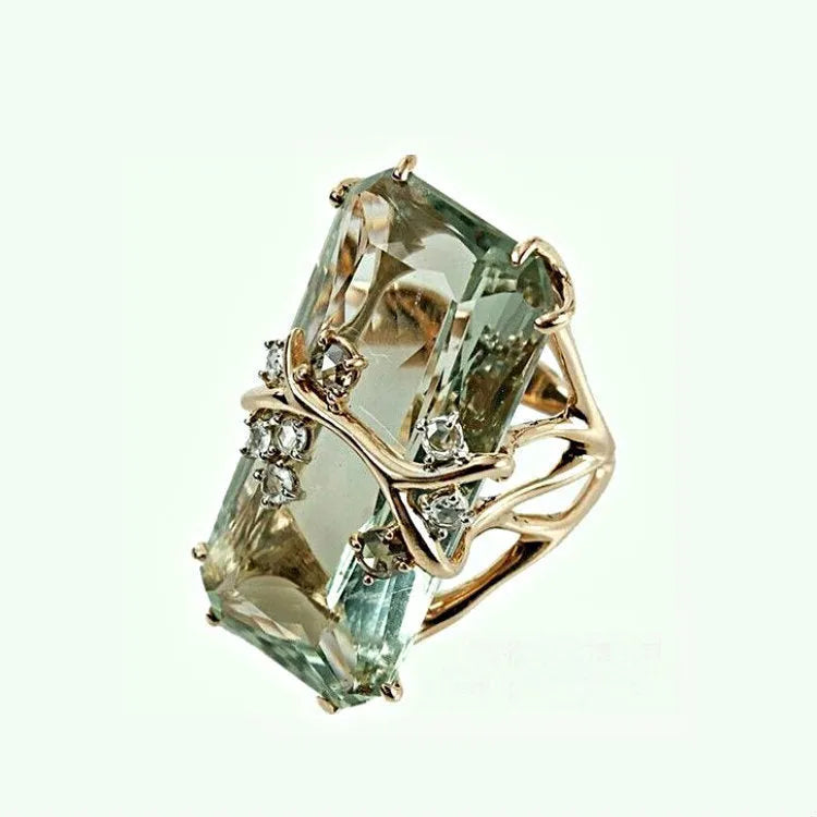 Lady's gold toned zinc alloy ring with navy blue inlaid diamond style stone