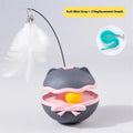 Electric self-righting cat teaser tumbler toy in lemon yellow, sky blue, and soft fog grey on a hardwood floor.