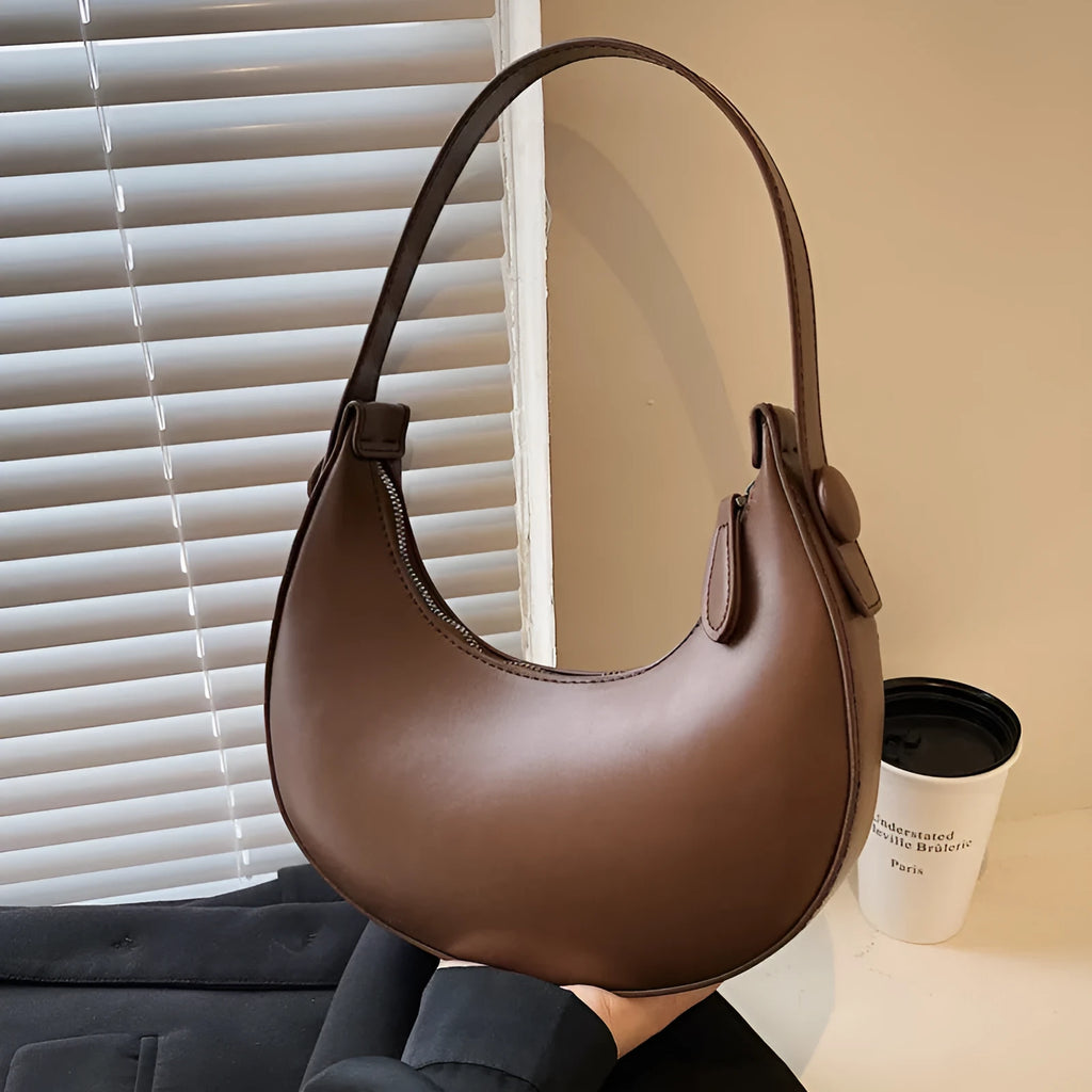 Women's retro brown dumpling-shaped PU leather shoulder bag showing front and internal zipper pocket.