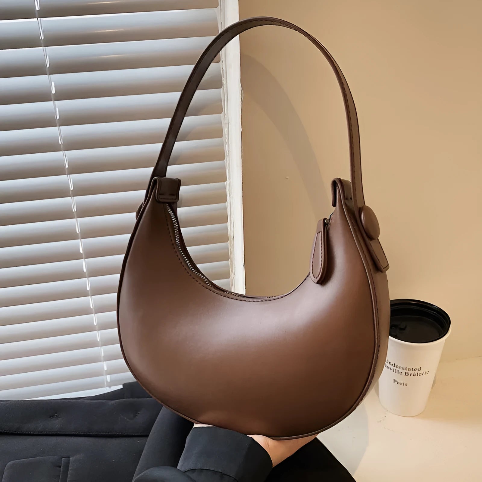 Women's retro brown dumpling-shaped PU leather shoulder bag showing front and internal zipper pocket.