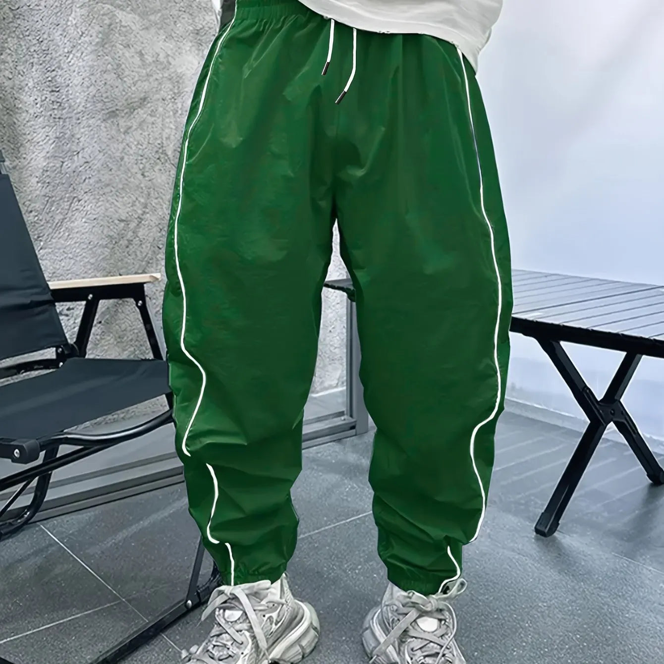 Men's blue bamboo fibre casual sports trousers with cropped length and loose fit on a hanger.