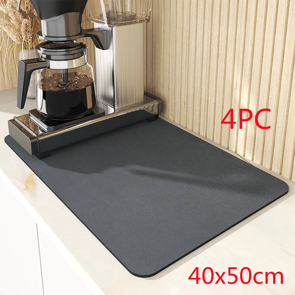 Black square kitchen drain drying mat with anti-slip rubber backing on a countertop