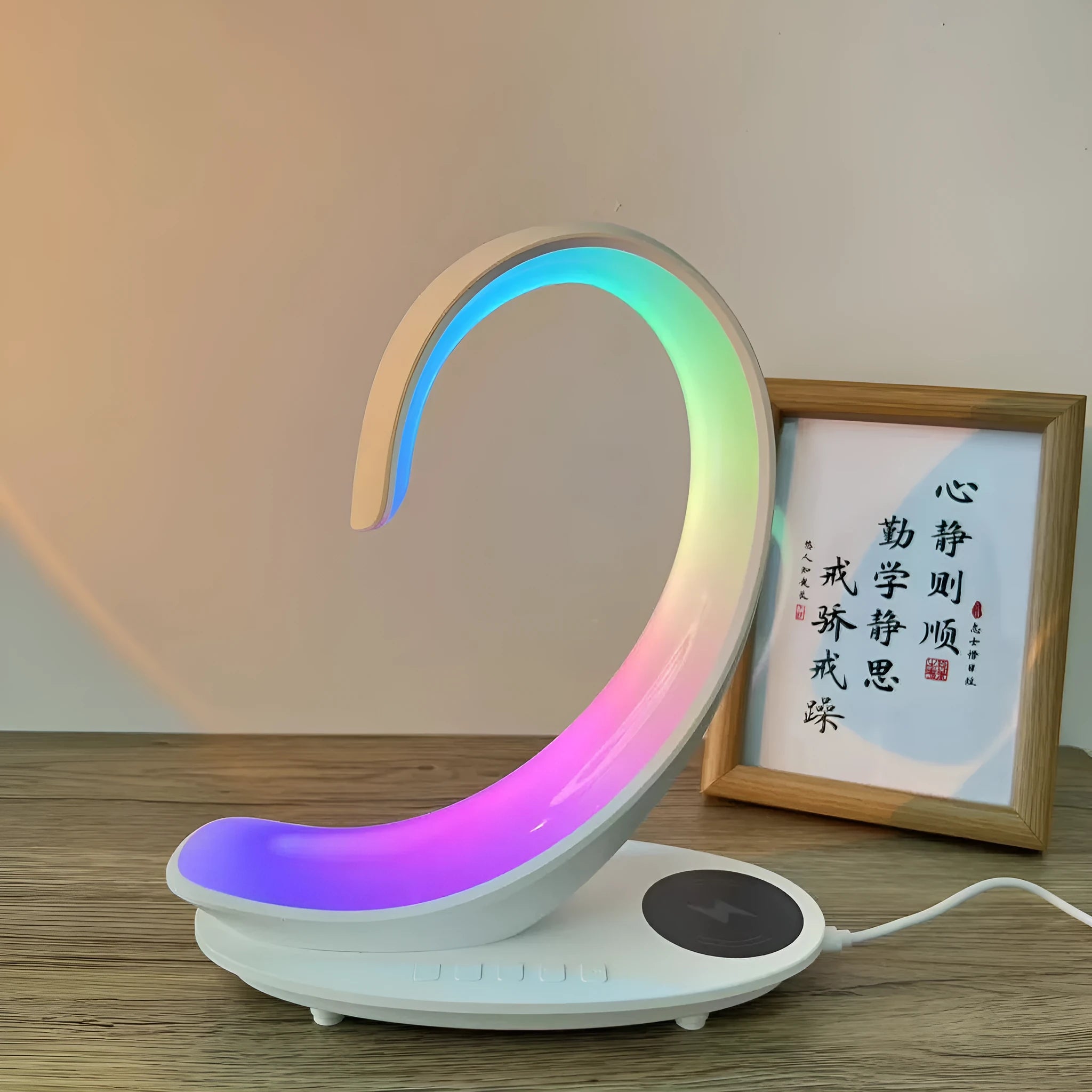 White swan-shaped desktop LED lamp with wireless charging pad and Bluetooth speaker.
