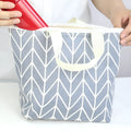 Arrow print water-resistant polyester makeup bag with a carry handle.