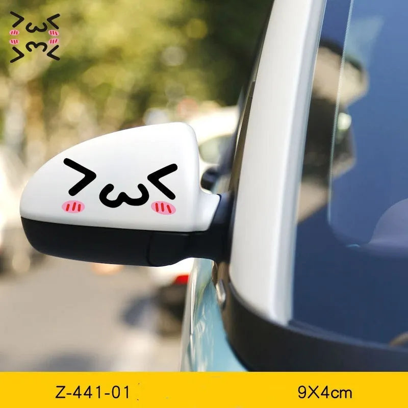 Pair of reflective cartoon car stickers with cute eyes on a car rearview mirror.