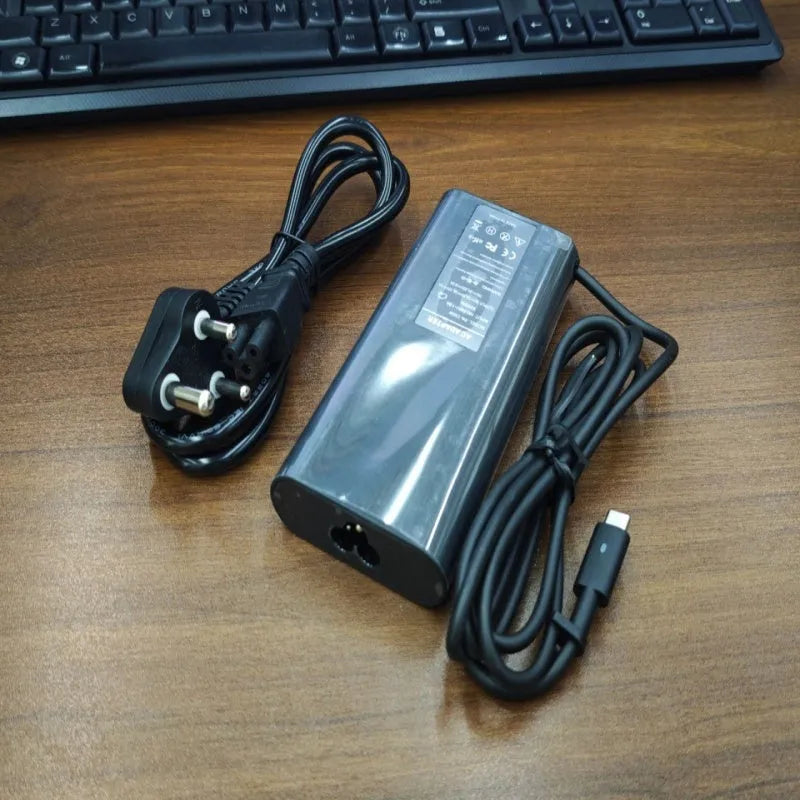 Black 65W laptop Type-C power adapter with multiple international plug cords