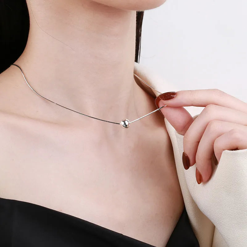 Silver necklace with small ball pendants on delicate chain for clavicle wear