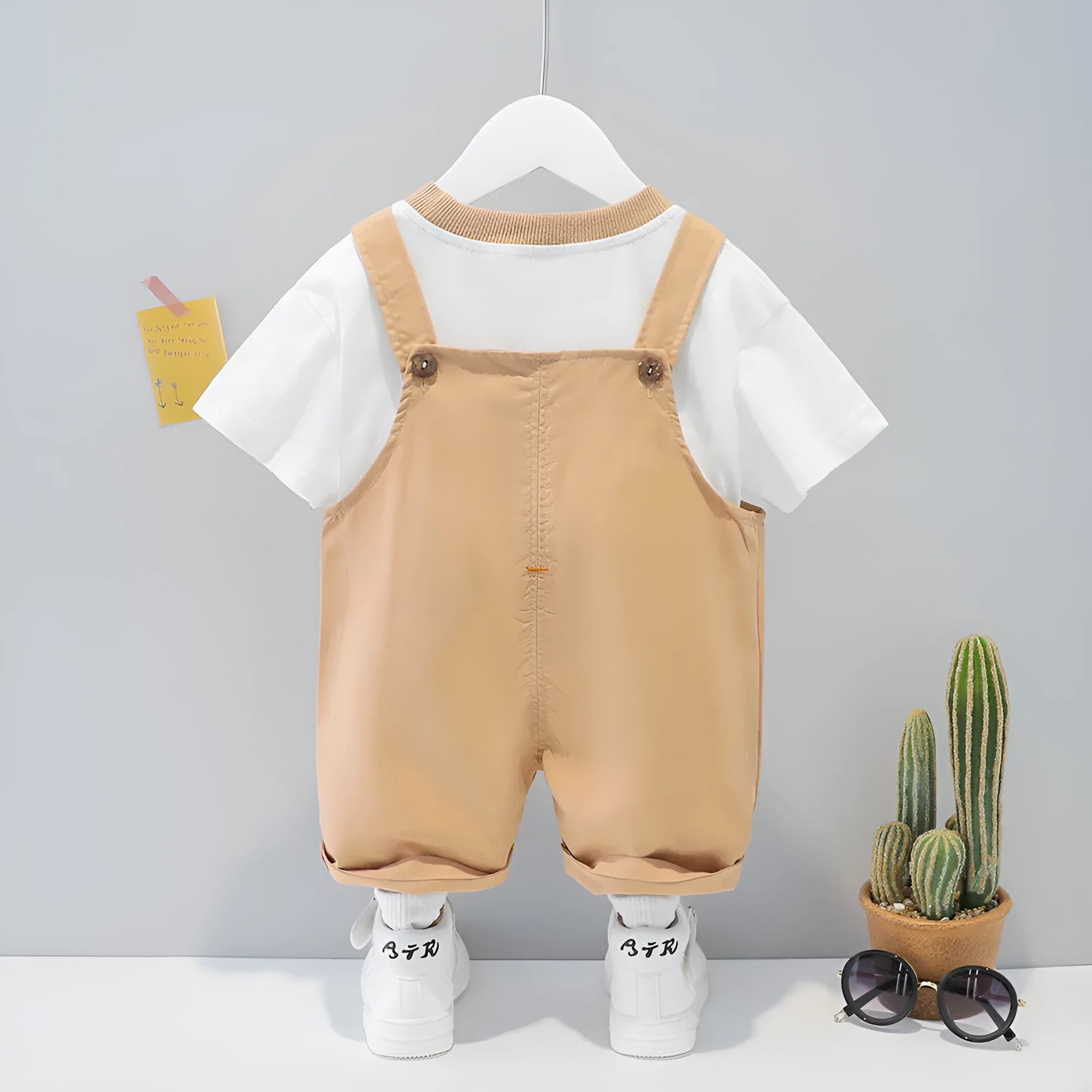 Cotton baby overalls with cartoon patterns in yellow, pink, and khaki colours