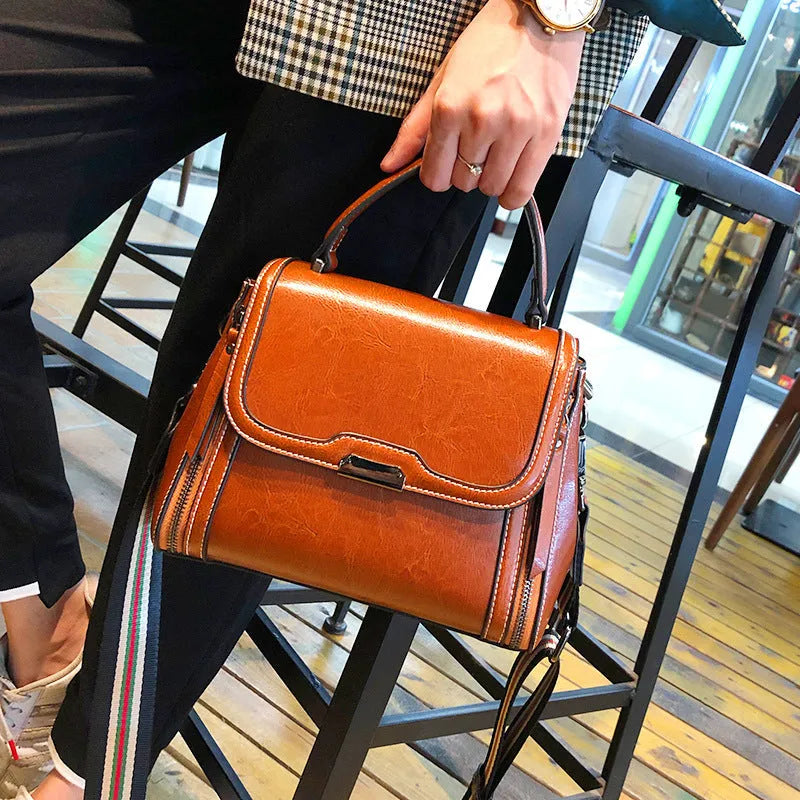 Genuine leather women's vintage messenger bag with multiple internal compartments in caramel colour