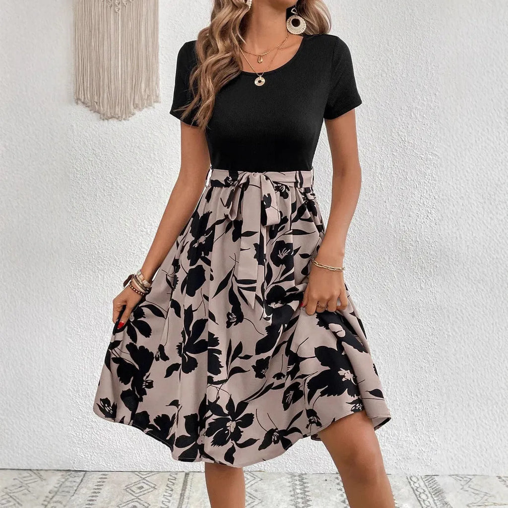 Khaki women's A-line dress with floral print, lace-up neckline, and a shoulder strap detail.