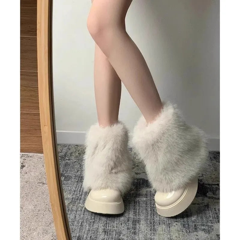 Women's black fleece-lined snow boots with a round toe, mid heel, and waterproof platform sole.