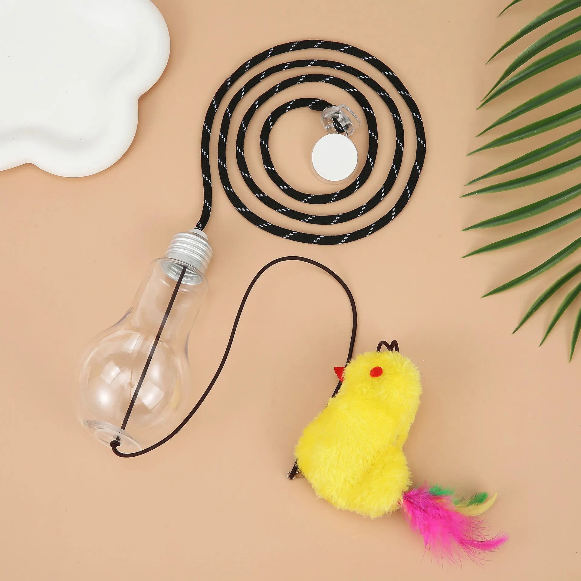 Interactive cat toy hanging from door frame with treat bulb and dangling mouse