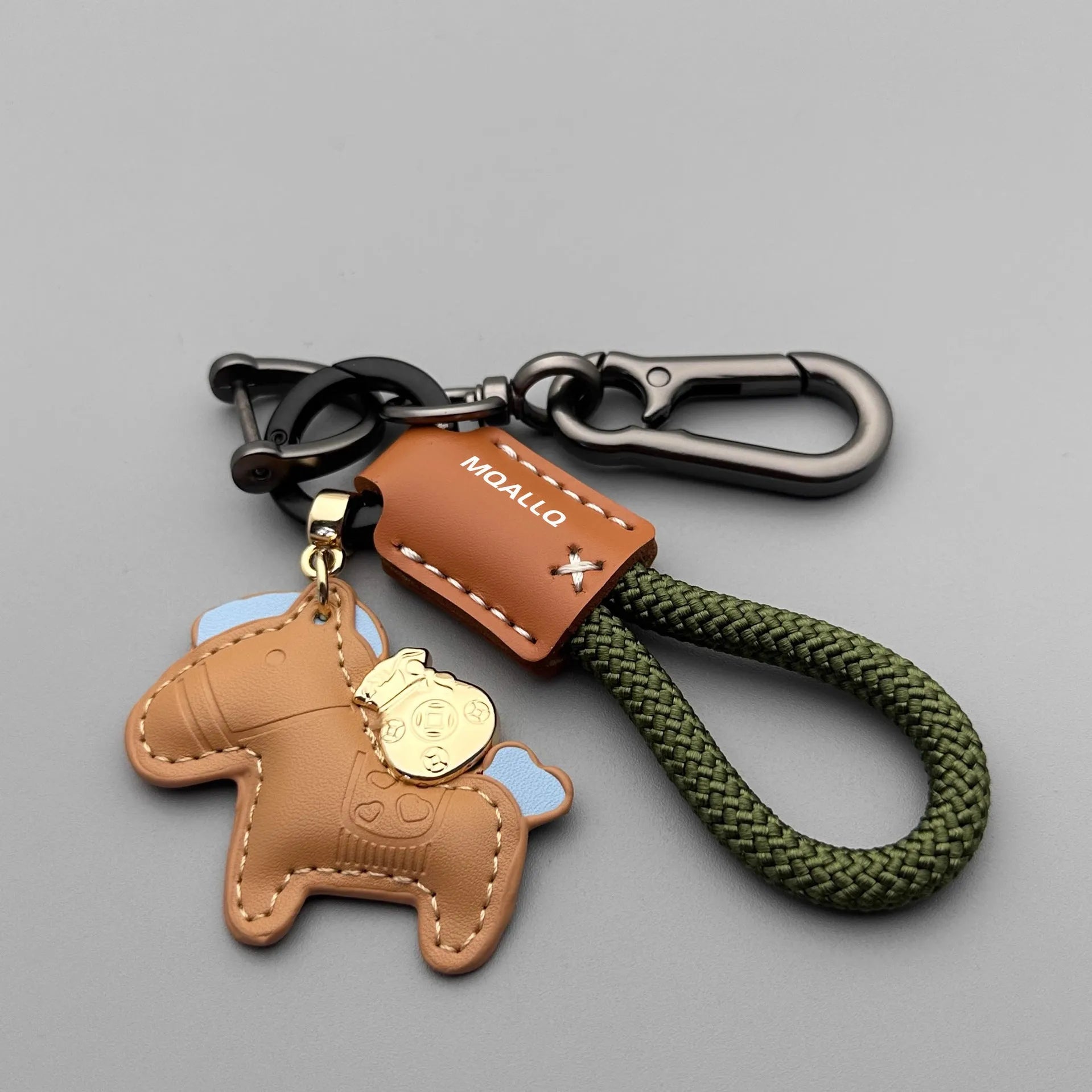 Handmade brown cowhide leather key ring with a zinc alloy pendant charm on a green flannel rope.