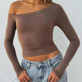 Women's black slim fit knitted cardigan pullover with long sleeves and cross-shoulder strap detail.