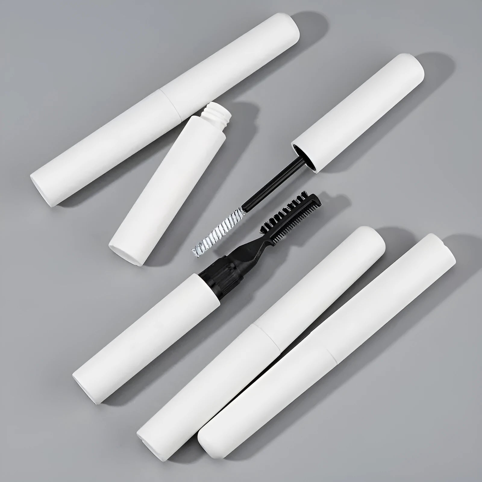 Eyebrow styling gel applicator in white or pink for natural brow shaping and long-lasting hold