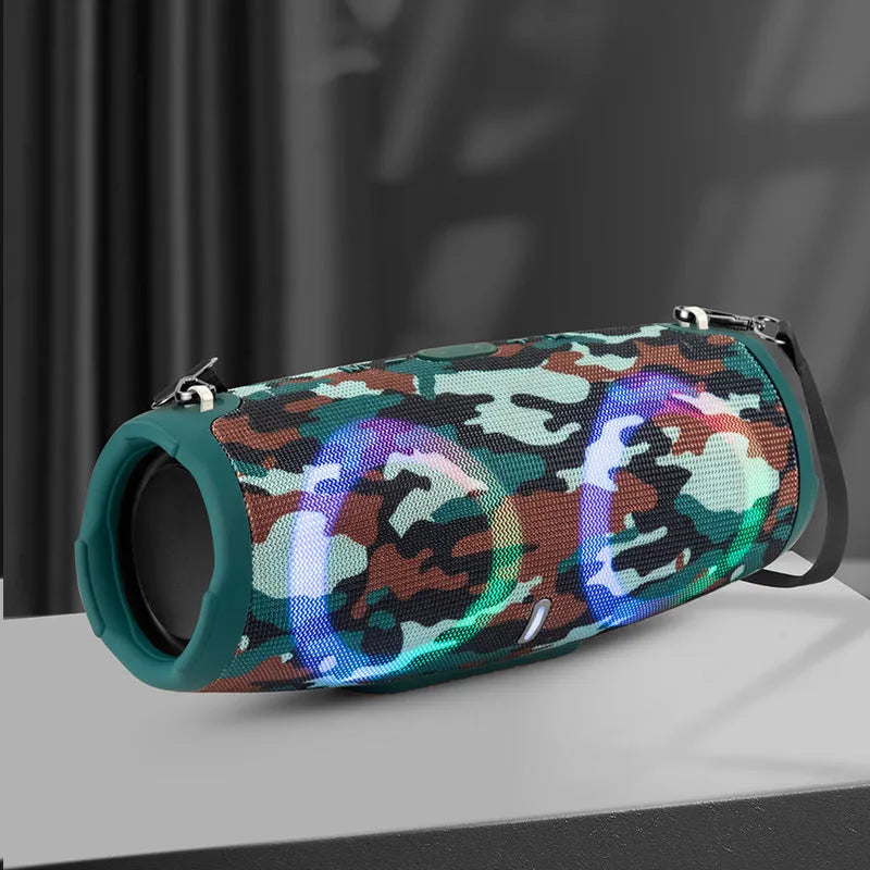 War Drum portable Bluetooth speaker with RGB lights in camouflage finish, showing carry strap and control buttons.