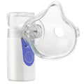 White columnar handheld USB nebuliser spray machine on a table with data cable.
