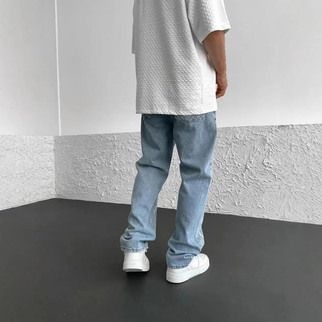 Men's blue straight-leg denim trousers with mid waist and zipper fly closure