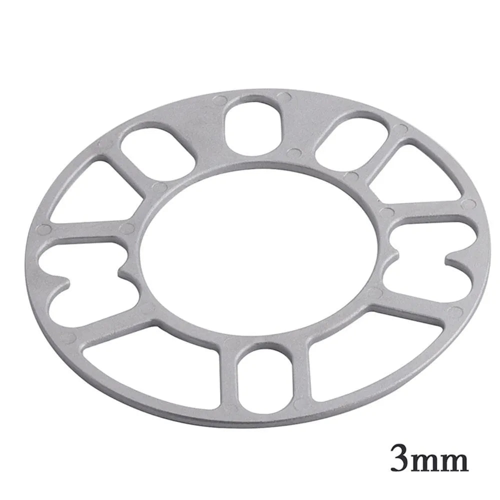 Set of metal hubcentric wheel spacer gaskets in different thicknesses for car brake caliper clearance.