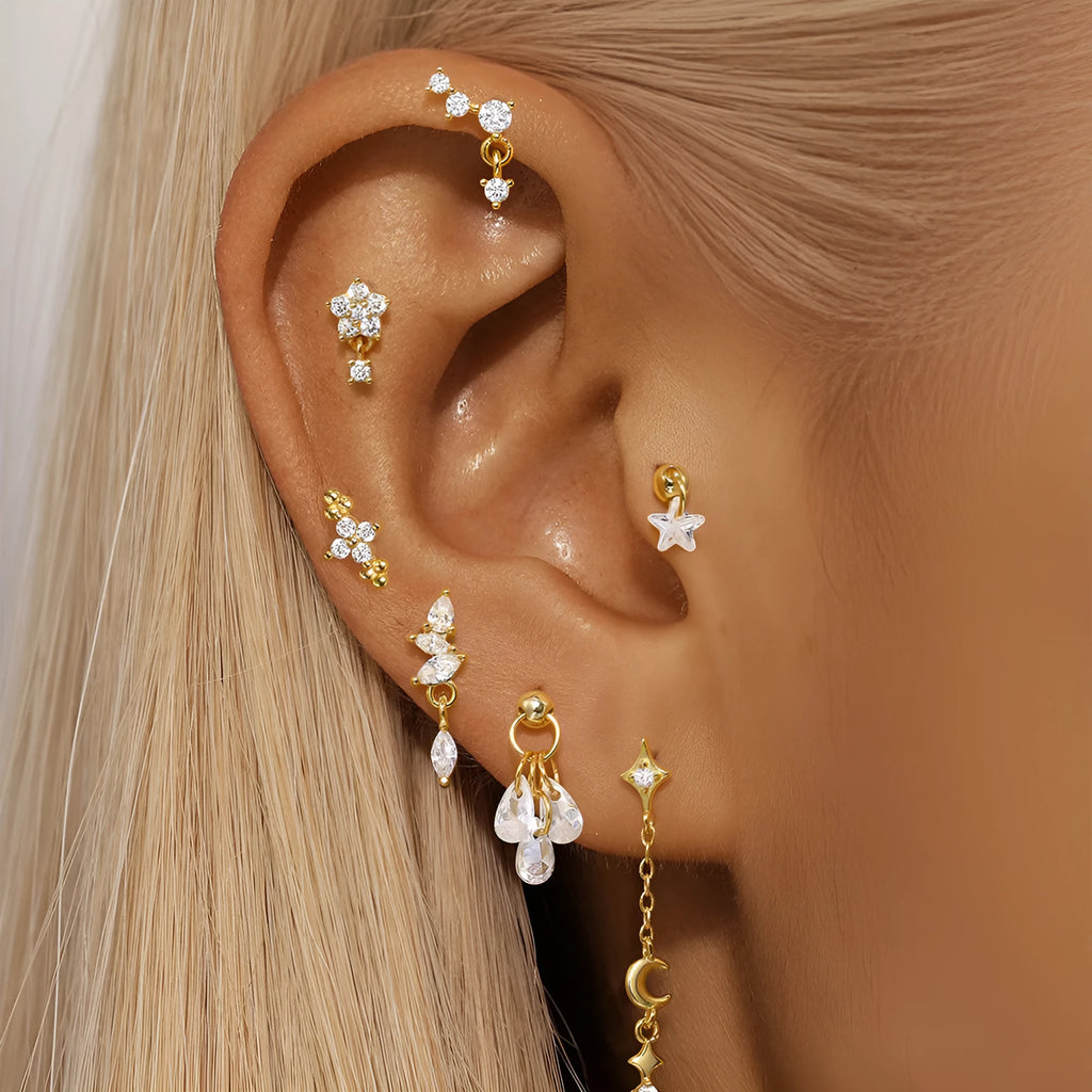 Geometric S925 sterling silver star and moon earrings with diamond accents in a gold colour.