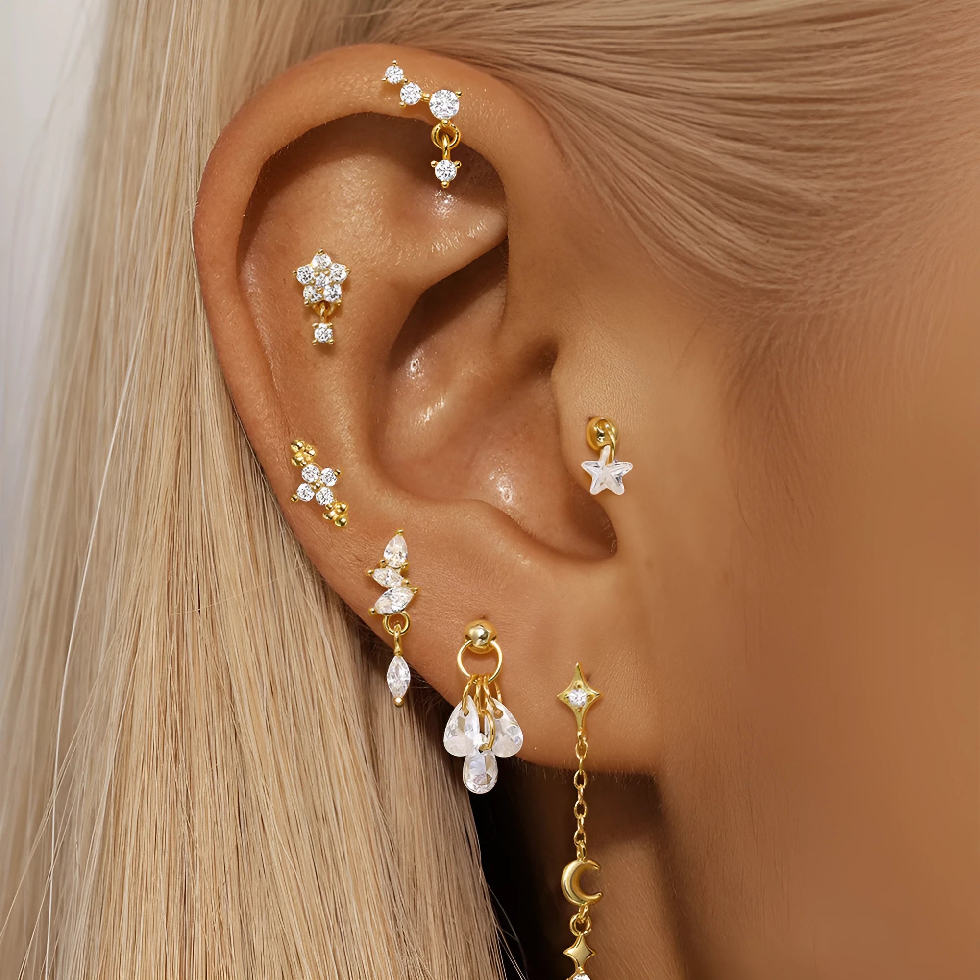 Geometric S925 sterling silver star and moon earrings with diamond accents in a gold colour.
