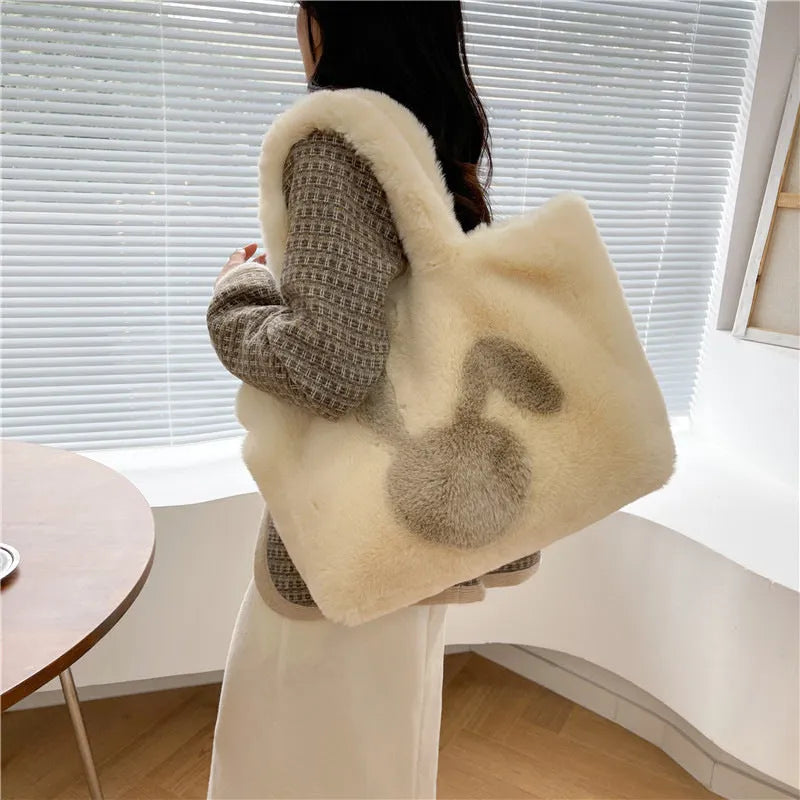 Cartoon rabbit ears plush shoulder tote bag in a solid colour on a model.