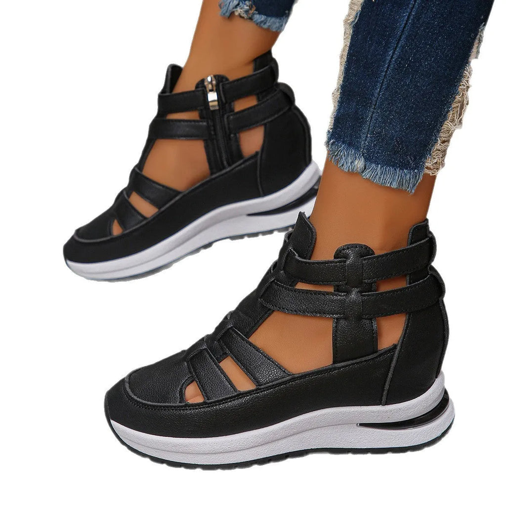 Women's black platform sandal with closed toe, hollow-out design, and Velcro ankle strap.