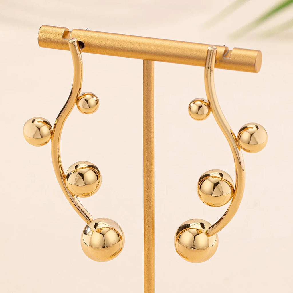 Pair of golden yellow round ball stud earrings made from iron in a popular size