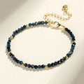 Blue tourmaline gemstone bracelet with 3mm cut beads on a white background.