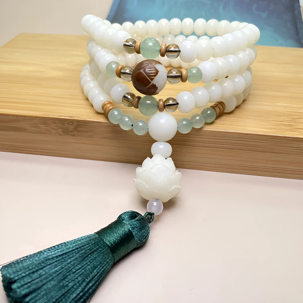 White Jade Bodhi bead bracelet with 108 beads, showing three different carved pattern styles.