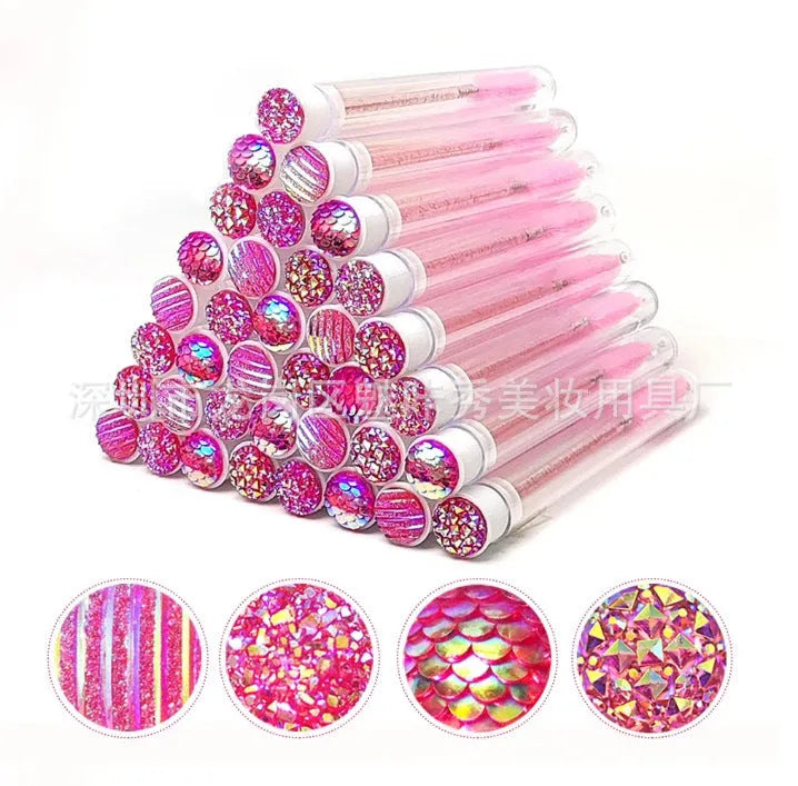 Set of coloured disposable mascara brushes inside clear plastic storage tubes on a white background.