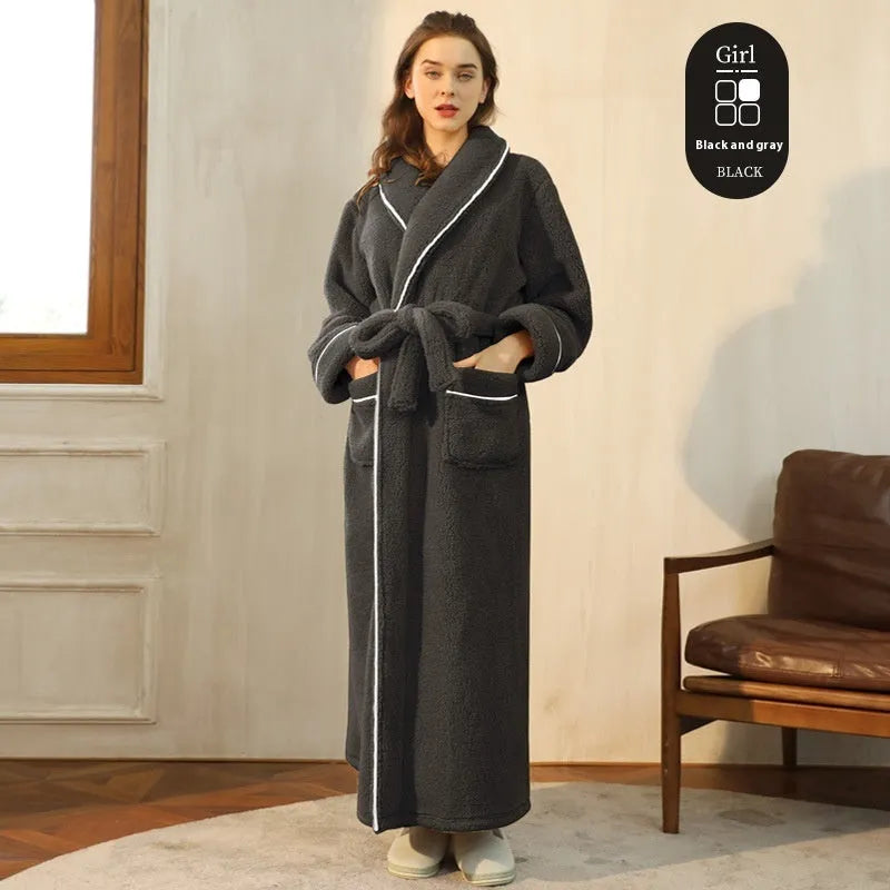A man and woman wearing matching thick, navy blue flannel bathrobes in a European style cut.