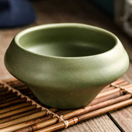 Tall porcelain ceramic Japanese soup bowl with underglaze vintage pattern on wooden table.