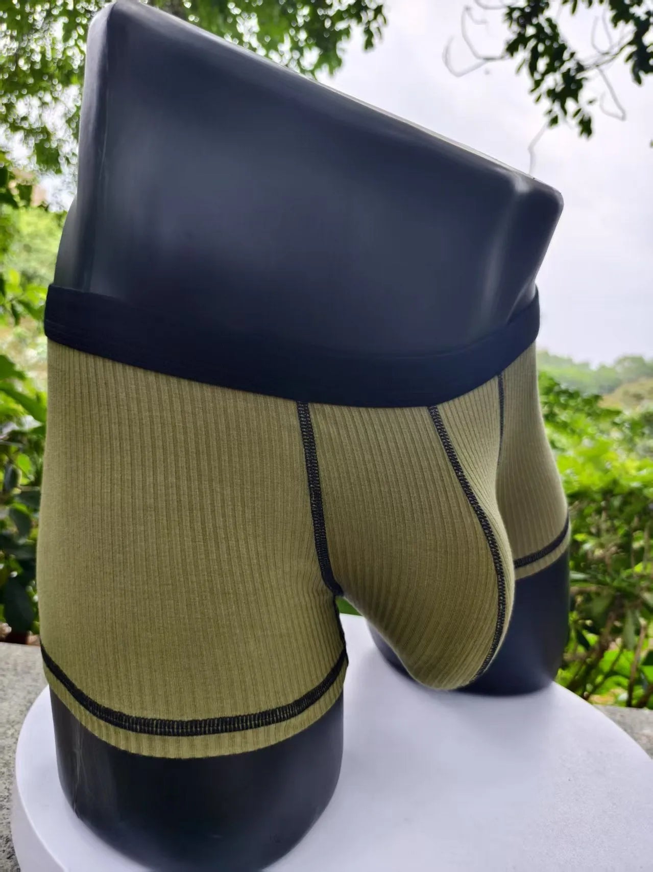 Men's solid colour breathable boxer shorts on a white background showing hip lifting design.