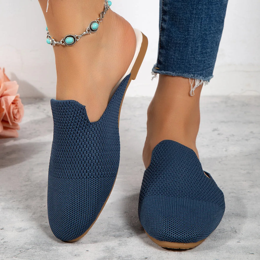 Apricot coloured mesh slip-on sandals with a round toe and flat rubber sole on a white background