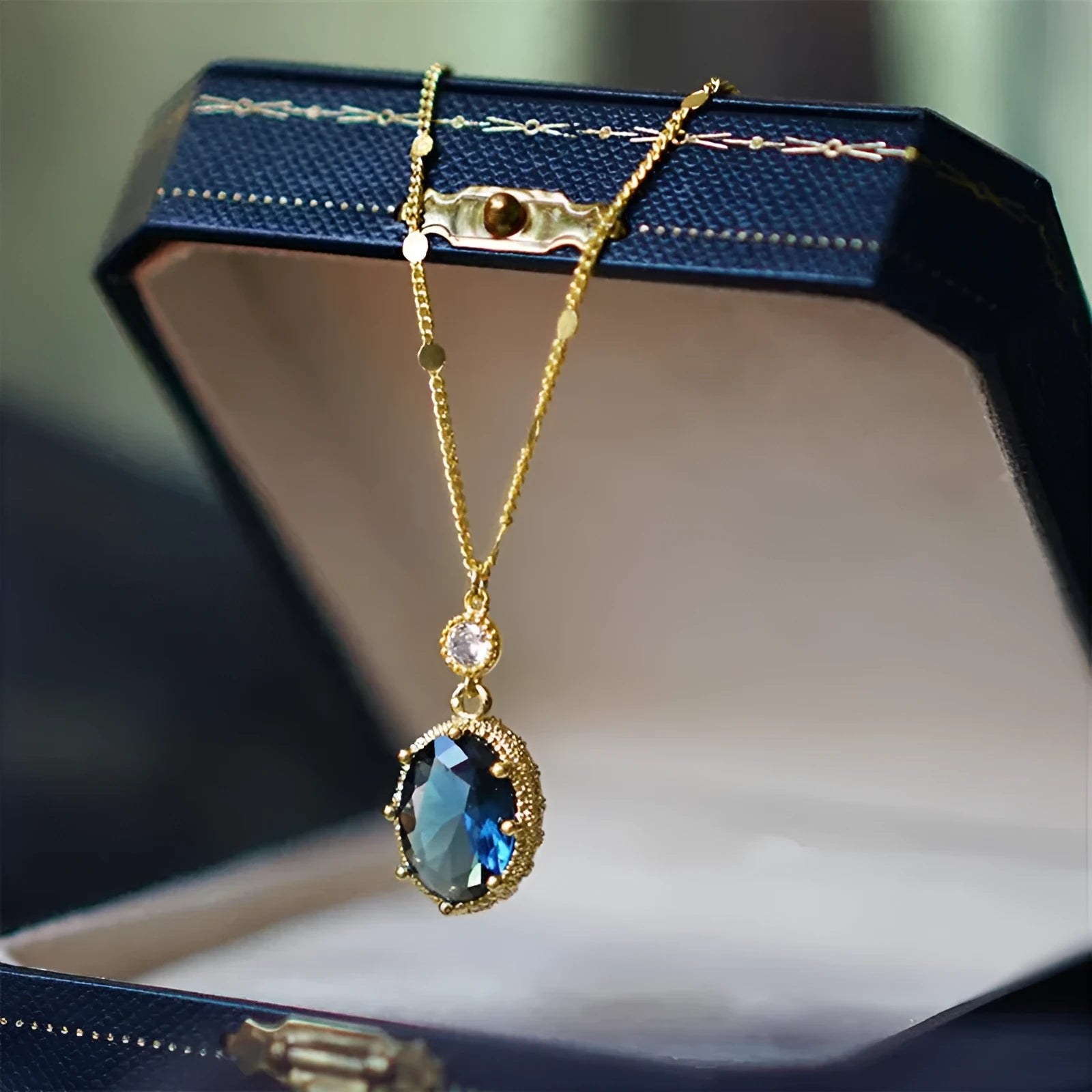 Gold geometric pendant necklace with French retro style on a model.