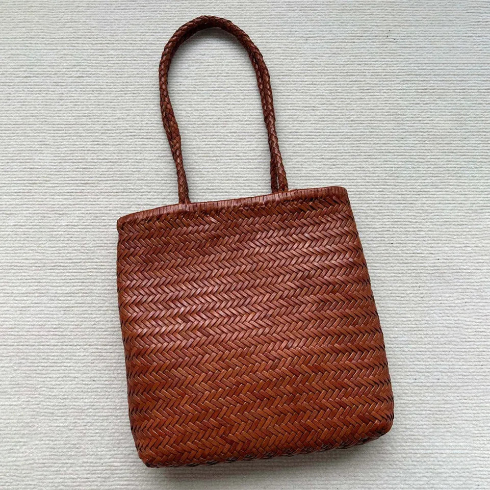 Brown handmade woven leather tote bag with a three-dimensional pocket.