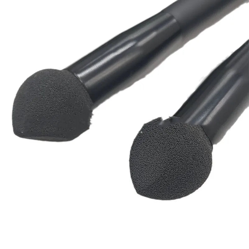 Black concealer brush with angled sponge tip and wooden handle for dark circle coverage