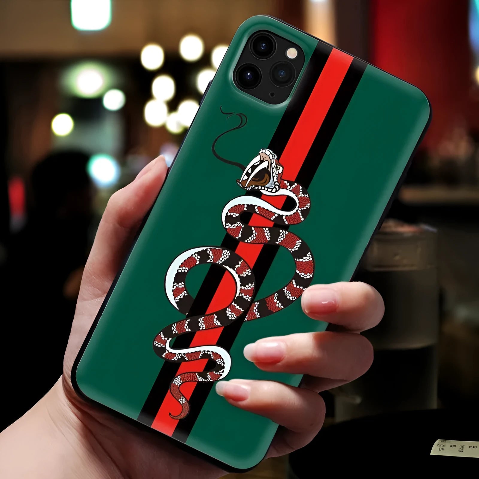 Black frosted silicone iPhone case featuring a cartoon snake design on the back.