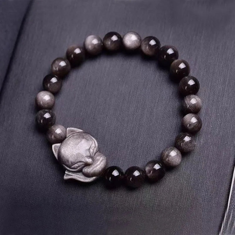Obsidian fox single ring bracelet with 8mm black stone bead and silver charm on elastic cord.